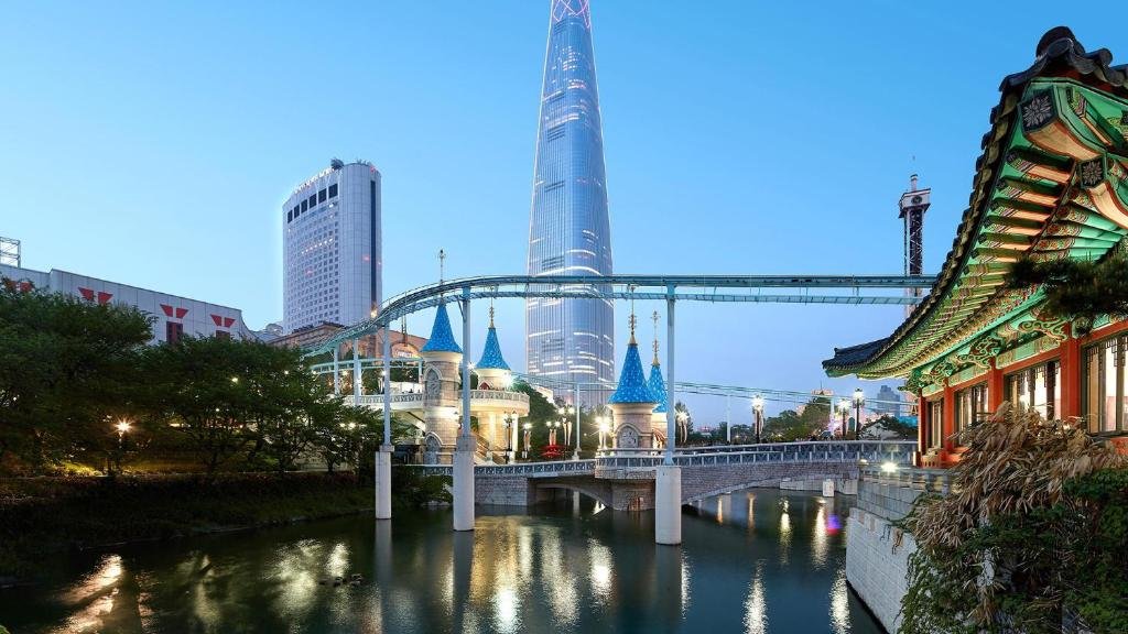 Lotte World Tower in Jamsil Seoul with Seokchon Lake and Lotte World theme park at night