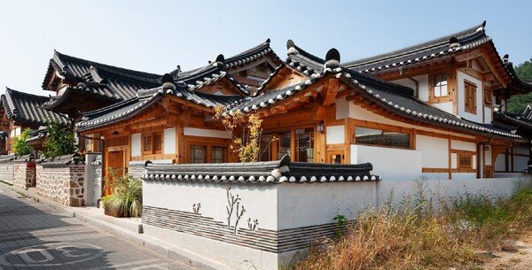 Traditional hanok house in Seochon Hanok Village in Seoul with tiled roofs and wooden exterior walls