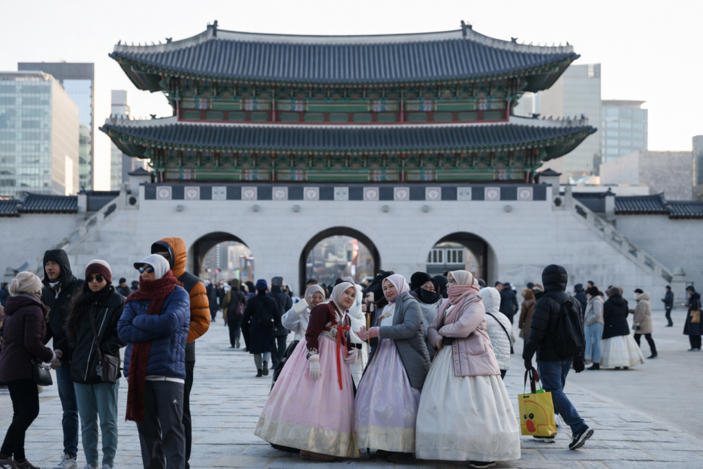 Tourists walking near Gwanghwamun Gate in central Seoul South Korea